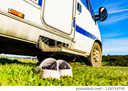Shoes clogs in front of camper car step 126554748
