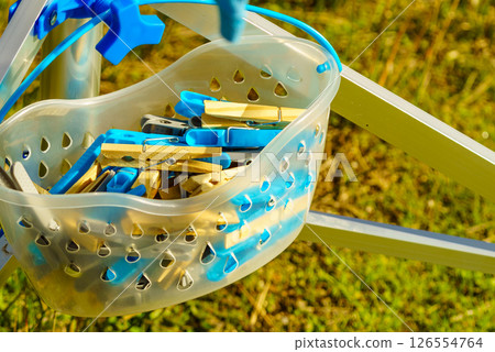 Drier and cloths pins in bucket used for hanging wet laundry Drier and cloths pins in bucket used for hanging wet laundry 126554764