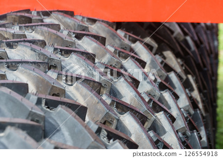 Detailed closeup of rubber tire wheel surface. 126554918