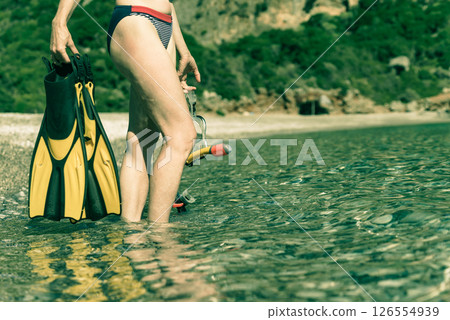 Woman with flippers snorkeling tube on beach 126554939