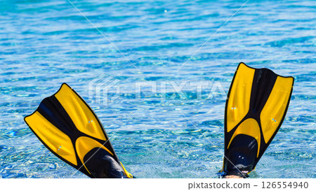 Feet in flippers fins on sea shore Feet in flippers fins on sea shore 126554940