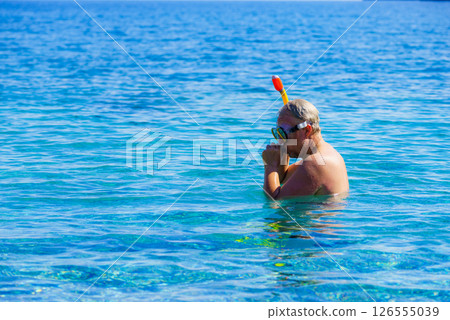 Man with snorkeling tube in sea 126555039