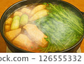 A warm and delicious hot pot dish with yellowtail, mizuna, and lots of green onions 126555332