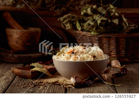 Traditional German sauerkraut on a old rustic wooden table. Traditional German sauerkraut on a old rustic wooden table. 126555927