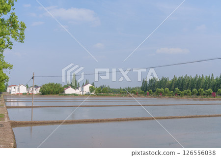 Rural countryside and modern houses under the blue sky Rural countryside and modern houses under the blue sky 126556038