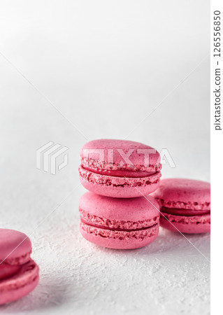 Stack of pink Macarons on white textured background isolated, copy space 126556850