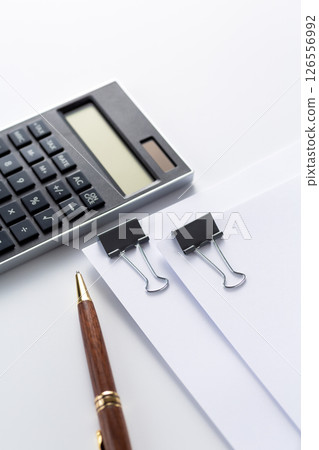 Documents and calculator clipped together Documents and calculator clipped together 126556992
