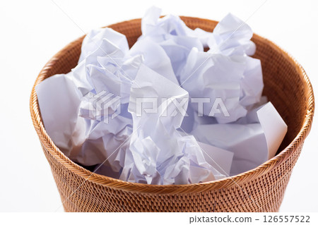 Trash can filled with rolled up paper Trash can filled with rolled up paper 126557522