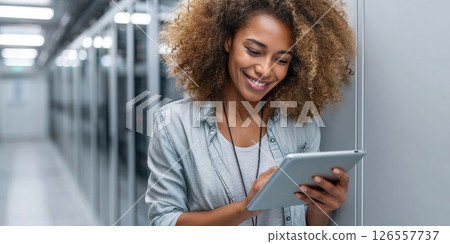 Smiling IT Technician with Tablet in Server Room 126557737