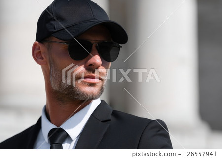 Vigilant Security Agent in Sunglasses and Cap Vigilant Security Agent in Sunglasses and Cap 126557941