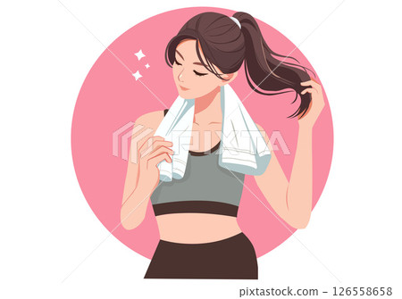 A woman in workout clothes and a towel around her neck is wiping away sweat after a workout. 126558658