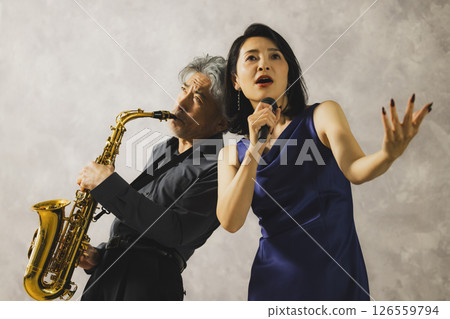 A man playing saxophone and a woman singing A man playing saxophone and a woman singing 126559794