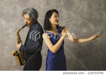 A man playing saxophone and a woman singing 126559796