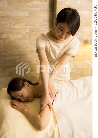 Senior woman receiving massage at beauty salon 126560436