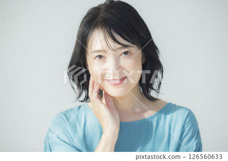 穿著藍色襯衫的中年婦女 穿著藍色襯衫的中年婦女 126560633
