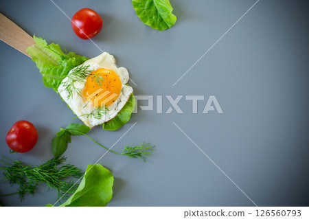 Close-up of healthy food, egg and salad on spatula, on gray background 126560793