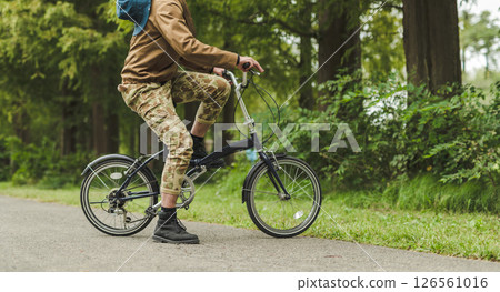 Man riding a bicycle Man riding a bicycle 126561016