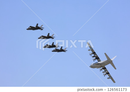 Stealth fighter jets flying in formation: F-35 126561173