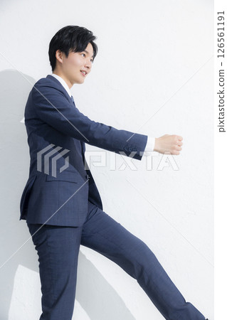A young businessman smiling looking at the camera 126561191