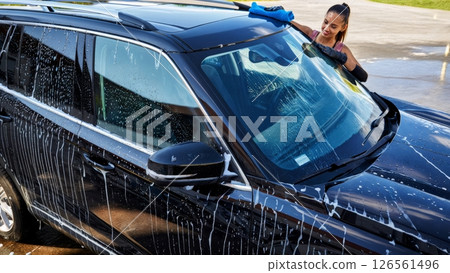 Car Wash Scene with Water Droplets on Glossy Black SUV 126561496
