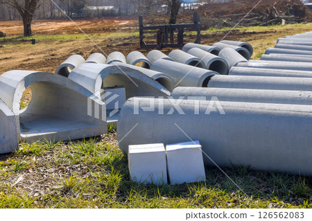 Concrete pipes blocks are neatly arranged on construction site in rural location under works day 126562083