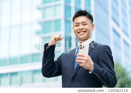 Young male business fist pump 126562210