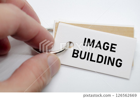 Image building slogan on white note suggesting reputation creation and consistent branding practices. 126562669