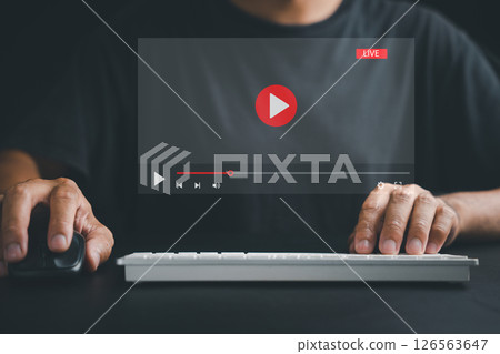 Experience the convenience of online connectivity as a man uses a computer for video streaming, attending live events, and engaging with educational tutorials. 126563647