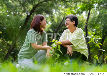 Old Asian Women and daughter join as volunteers for reforestation, earth conservation activities for reduce global warming growth feature and take care nature earth. Environment Concept Old Asian Women and daughter join as volunteers for reforestation, earth conservation activities for reduce global warming growth feature and take care nature earth. Environment Concept 126563734