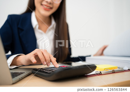 Portrait of smiling beautiful business asian woman at modern office desk using laptop to work and write notes, Business people employee freelance online marketing e-commerce telemarketing concept. 126563844