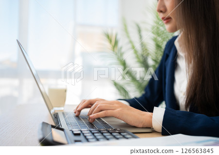 Portrait of smiling beautiful business asian woman at modern office desk using laptop to work and write notes, Business people employee freelance online marketing e-commerce telemarketing concept. 126563845
