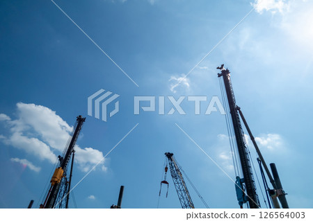 Construction machinery shining against the blue sky Construction machinery shining against the blue sky 126564003