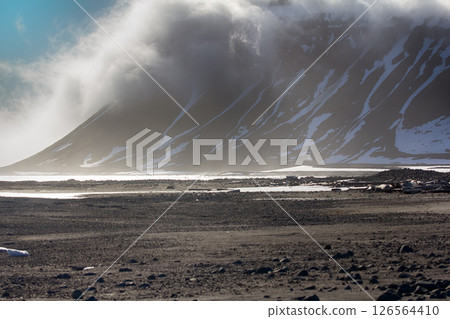 Cloud caught on the glacial sheet, nunatak in fog 126564410