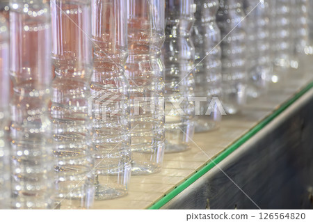 Close up scene of the bottom of the PET bottle on the conveyor belt. Close up scene of the bottom of the PET bottle on the conveyor belt. 126564820