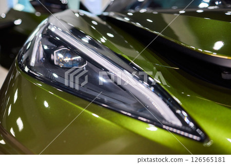 Close up of a cars headlight, part of automotive design 126565181