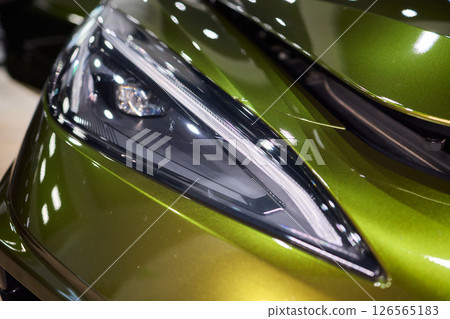 Close up of a cars headlight, part of automotive design Close up of a cars headlight, part of automotive design 126565183