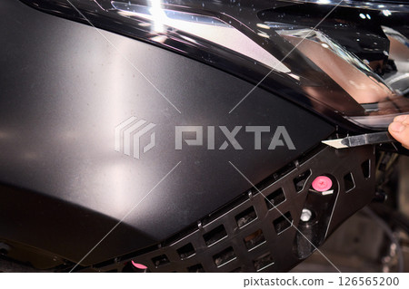 Applying a Protective Film on the Surface of Your Car for Enhanced Durability and Shine 126565200