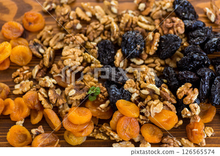 Background of prunes, dried apricots and nuts on a wooden table 126565574