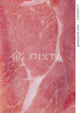 Thinly sliced ham meat as a background macro photo. Thinly sliced ham meat as a background macro photo. 126566377