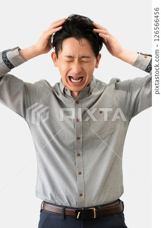 A worried male businessman holding his head 126566456