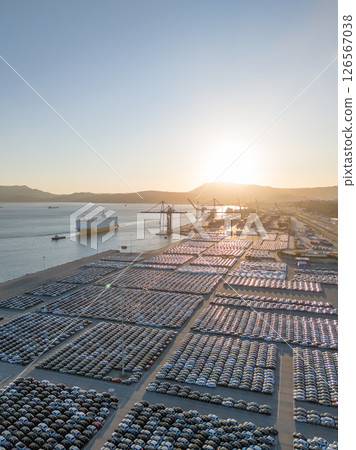 New Cars on Parking Lot and RORO cargo ship in Port of Setubal. Aerial View 126567038