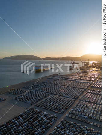 New Cars on Parking Lot and RORO cargo ship in Port of Setubal. Aerial View 126567039