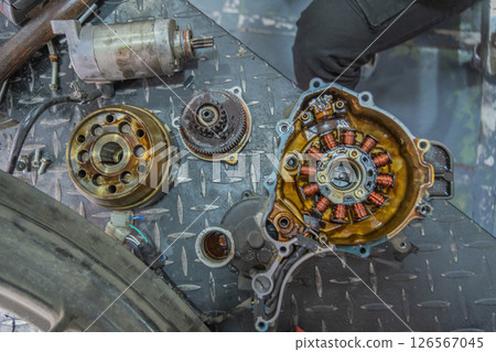 Mechanic checking gearbox in a workshop 126567045