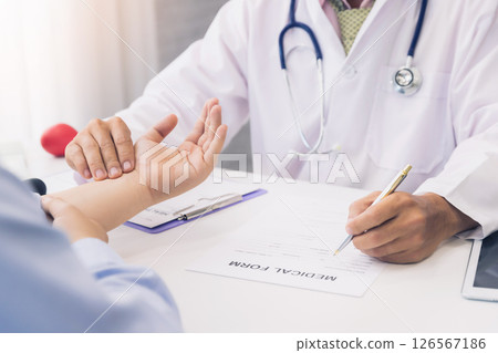 Doctor examining patient pulse by hands. Healthcare and medical service. 126567186