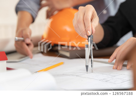 Group of two coworkers working with blueprint in office. co-working teamwork concept. 126567188