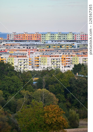Original prefabricated houses on a housing estate from the communist era in Eastern and Central Europe after reconstruction.. Facade of a modern apartment building with windows and balconies. Czech 126567365
