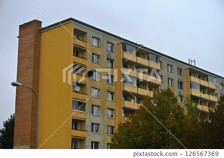 Original prefabricated houses on a housing estate from the communist era in Eastern and Central Europe after reconstruction.. Facade of a modern apartment building with windows and balconies. Czech Original prefabricated houses on a housing estate from the communist era in Eastern and Central Europe after reconstruction.. Facade of a modern apartment building with windows and balconies. Czech 126567369