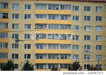 Original prefabricated houses on a housing estate from the communist era in Eastern and Central Europe after reconstruction.. Facade of a modern apartment building with windows and balconies. Czech Original prefabricated houses on a housing estate from the communist era in Eastern and Central Europe after reconstruction.. Facade of a modern apartment building with windows and balconies. Czech 126567371