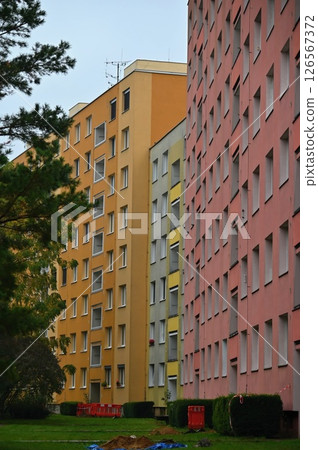 Original prefabricated houses on a housing estate from the communist era in Eastern and Central Europe after reconstruction.. Facade of a modern apartment building with windows and balconies. Czech Original prefabricated houses on a housing estate from the communist era in Eastern and Central Europe after reconstruction.. Facade of a modern apartment building with windows and balconies. Czech 126567372