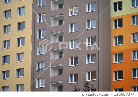 Original prefabricated houses on a housing estate from the communist era in Eastern and Central Europe after reconstruction.. Facade of a modern apartment building with windows and balconies. Czech 126567374